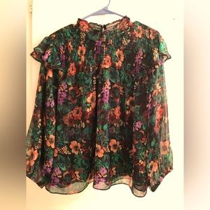 Light weight dressy blouse. Long see though sleeves. High around the neck.